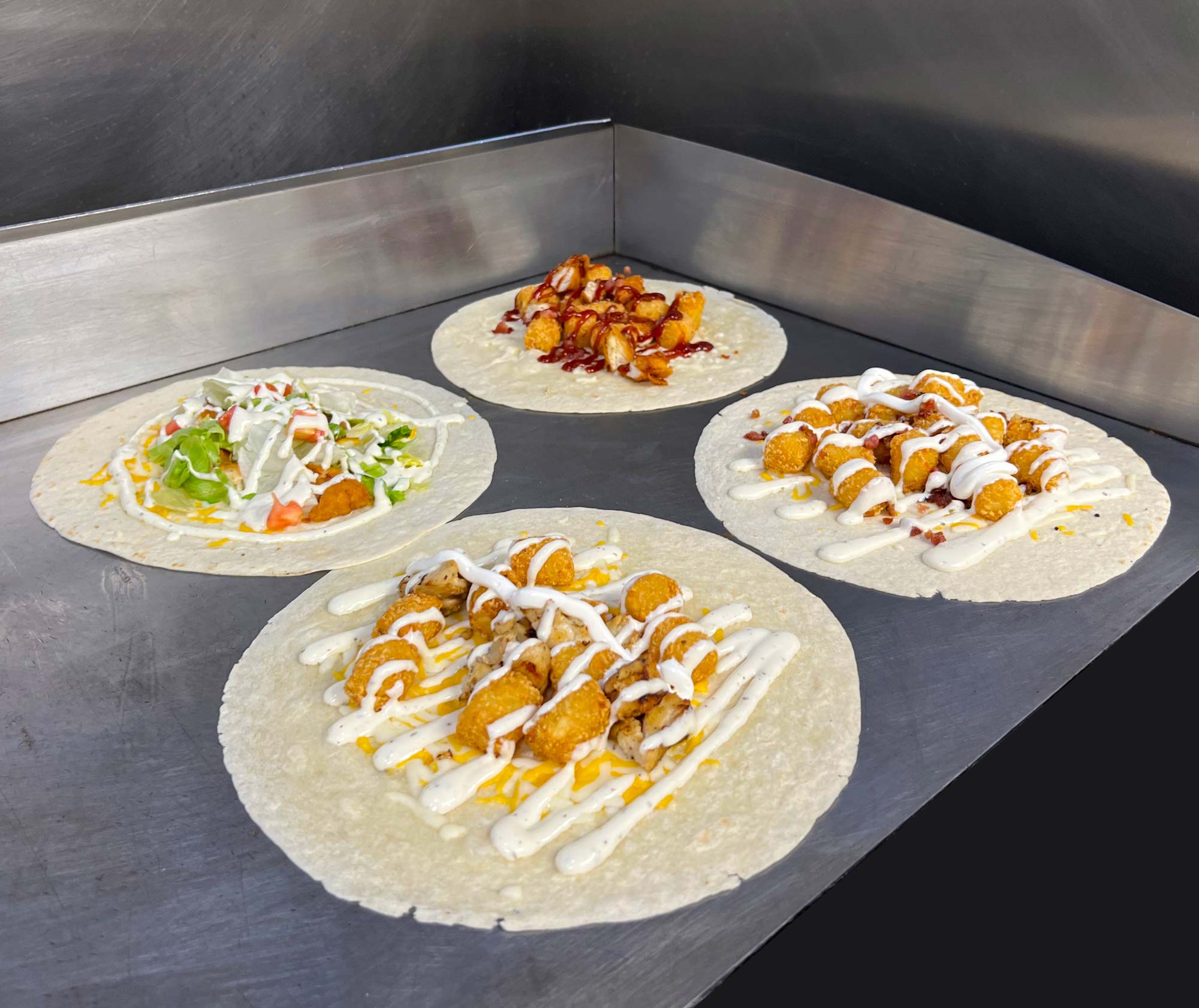 four wraps on a grill